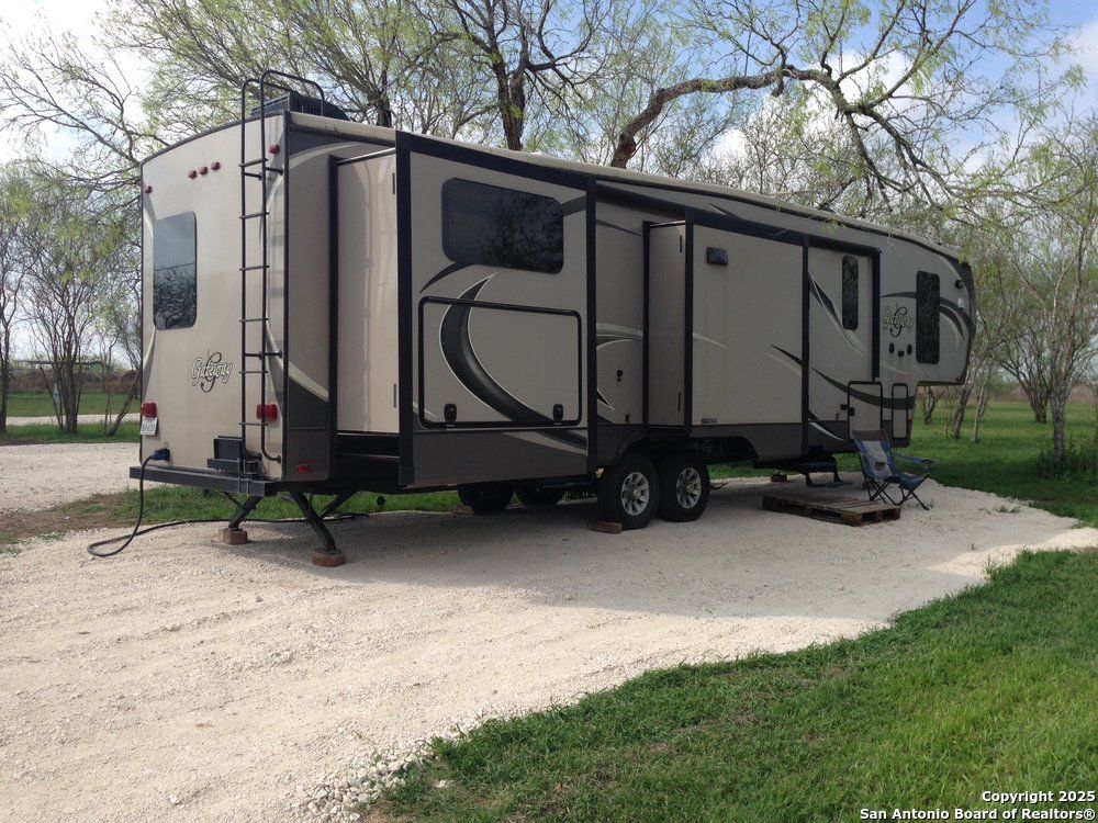 1197 FM 2443 Road Kenedy, TX 78119 - Photo 14 of 18 a view of a house with backyard and sitting area