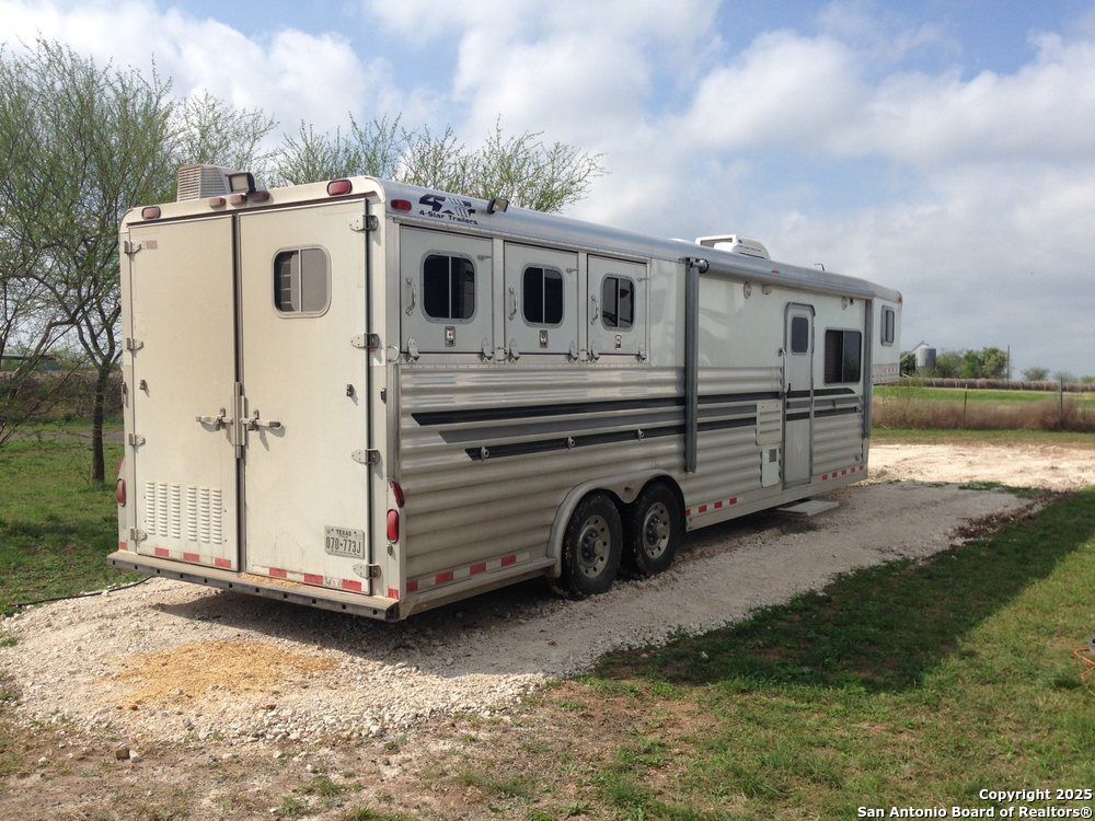 1197 FM 2443 Road Kenedy, TX 78119 - Photo 16 of 18 a view of a house with a yard