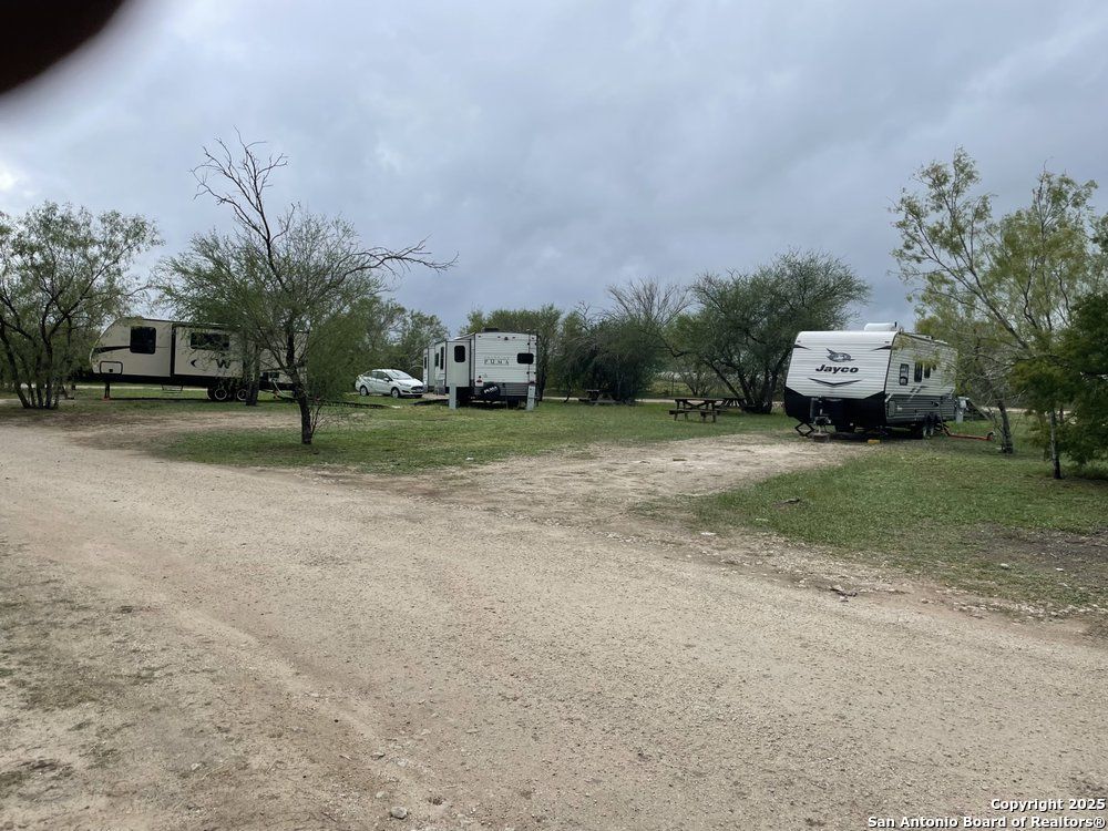 1197 FM 2443 Road Kenedy, TX 78119 - Photo 18 of 18 a view of a house with a yard
