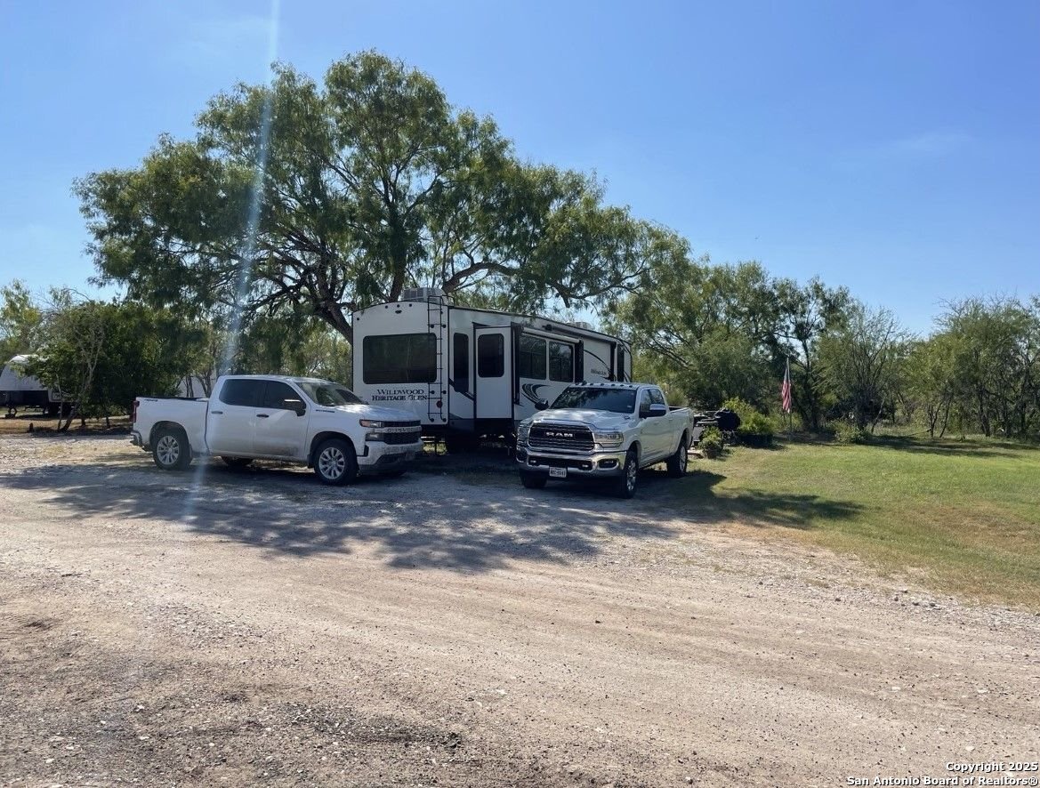 1197 FM 2443 Road Kenedy, TX 78119 - Photo 3 of 18 a view of a car parked in a yard