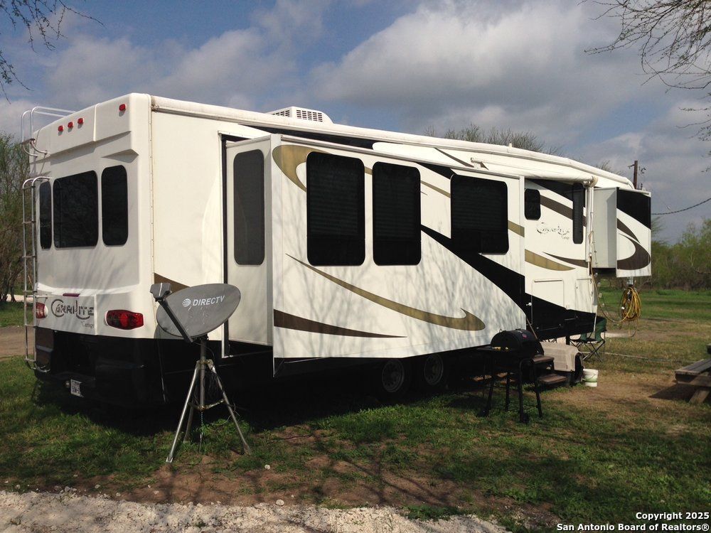 1197 FM 2443 Road Kenedy, TX 78119 - Photo 8 of 18 a front view of a house with a yard