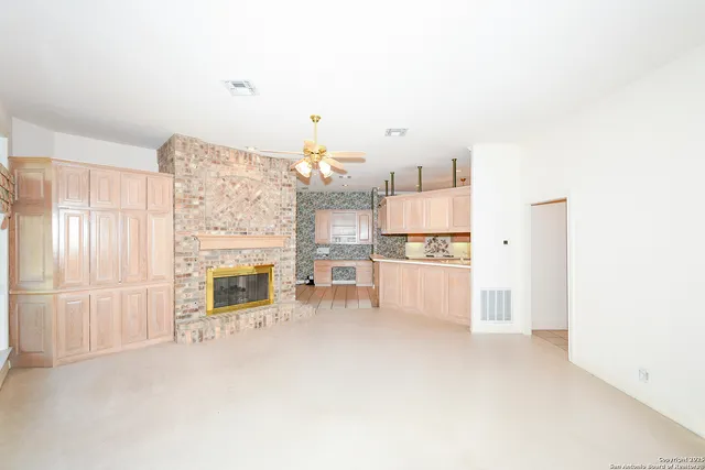 a view of kitchen with furniture and refrigerator