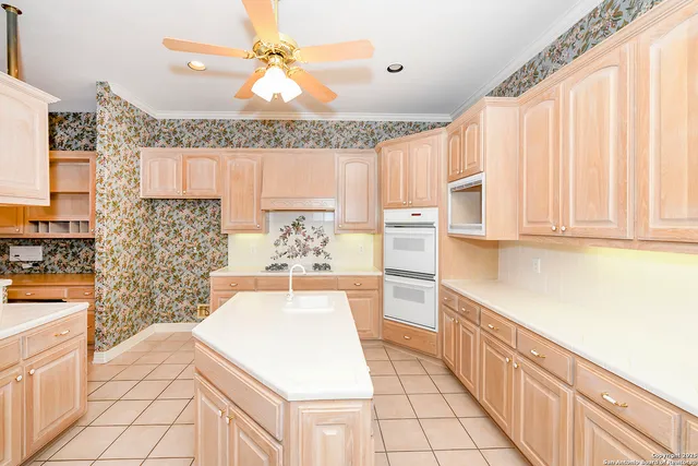 a kitchen with stainless steel appliances a stove a sink and a microwave