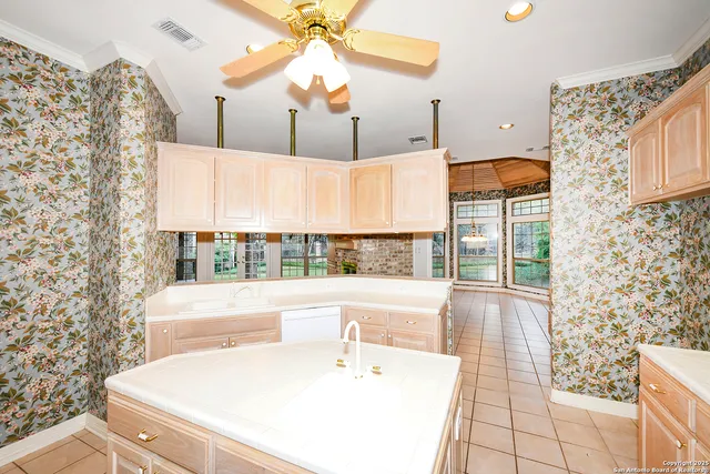 a white bath tub sitting in a bathroom next to a window