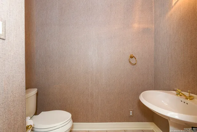 a bathroom with a sink a toilet and mirror