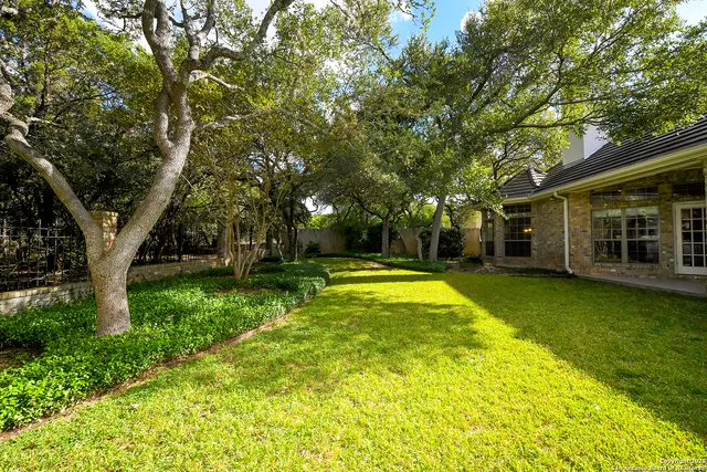 a view of a house with swimming pool and sitting area