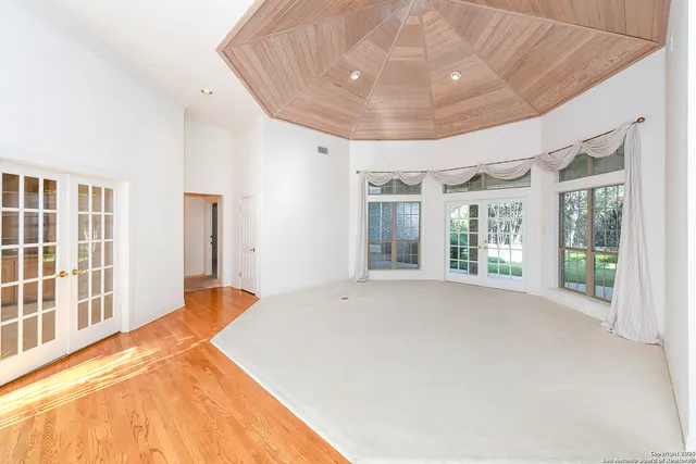 a spacious bedroom with a large bed and a large window