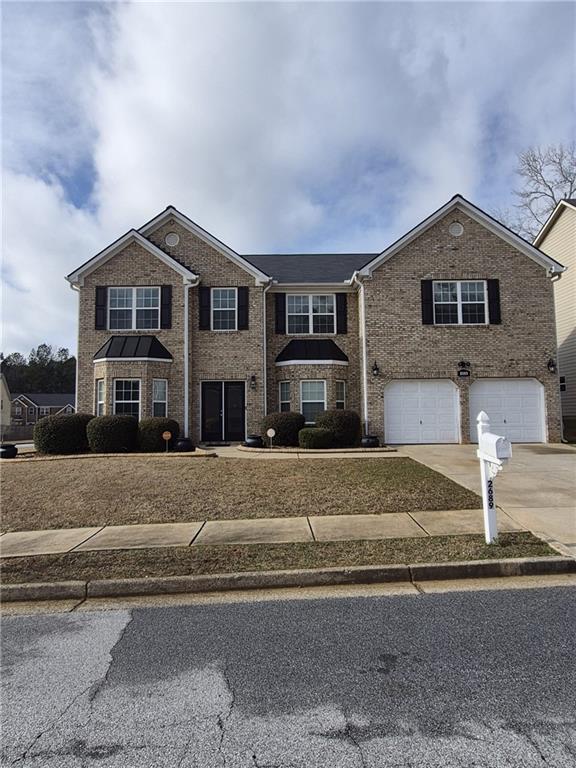 2689 Muskeg Court Southwest Atlanta, GA 30331 - Photo 1 of 35 a front view of a house with a garden and parking