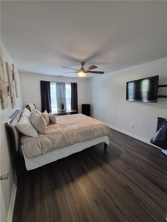 2689 Muskeg Court Southwest Atlanta, GA 30331 - Photo 17 of 35 a bedroom with a bed and a flat screen tv