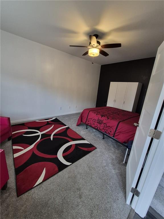 2689 Muskeg Court Southwest Atlanta, GA 30331 - Photo 21 of 35 a bedroom with a bed and a chandelier