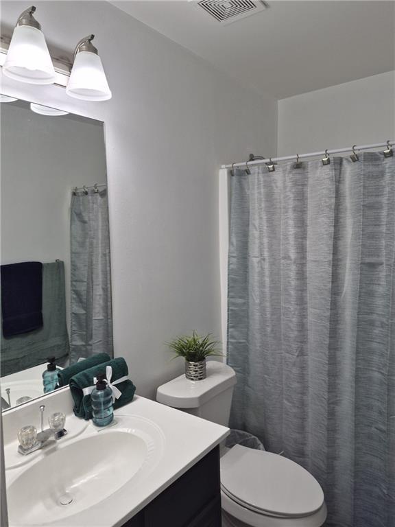 2689 Muskeg Court Southwest Atlanta, GA 30331 - Photo 35 of 35 a bathroom with a sink a toilet and shower curtain
