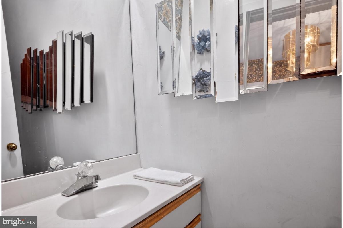 10320 Glen Road Potomac, MD 20854 - Photo 45 of 75 a bathroom with a sink and a mirror