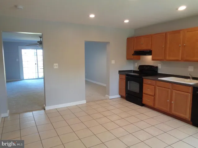 a kitchen with stainless steel appliances a sink stove and cabinets