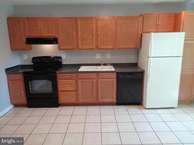 a kitchen with a cabinets and a stove top oven