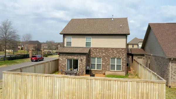 a view of a house with roof deck and furniture