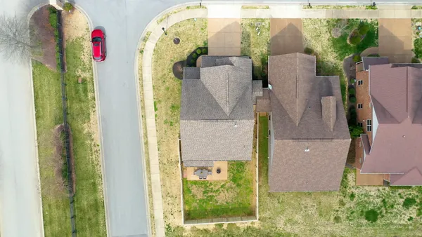 an aerial view of a house with a swimming pool
