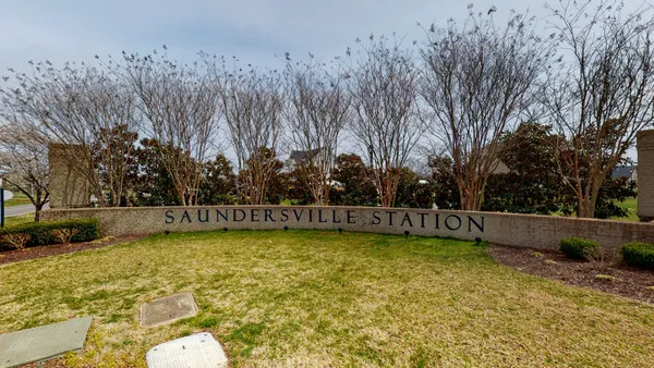 a view of a swimming pool with an outdoor seating and a bench
