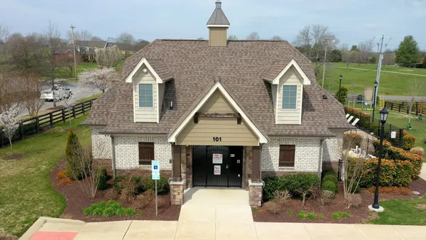 a aerial view of a house next to a yard