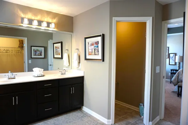 a spacious bathroom with a double vanity sink and a mirror