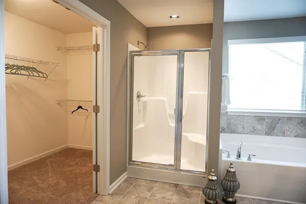 a bathroom with a shower and a tub