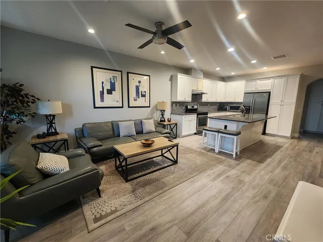 a living room with furniture and kitchen view