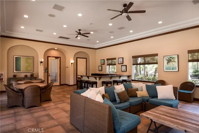 a living room with furniture kitchen view and a large window