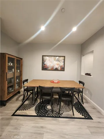 a living room with a piano and a table