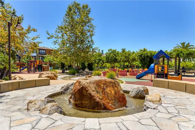 a view of a swimming pool with a lounge chair and palm trees