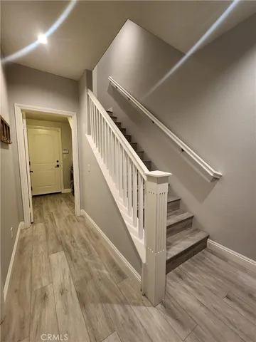 a view of entryway and hall with wooden floor