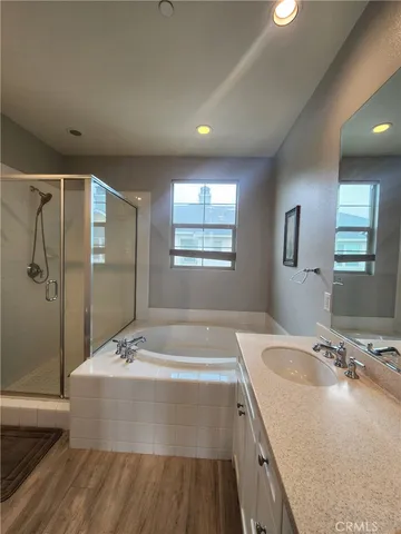 a bathroom with a granite countertop sink a toilet and shower