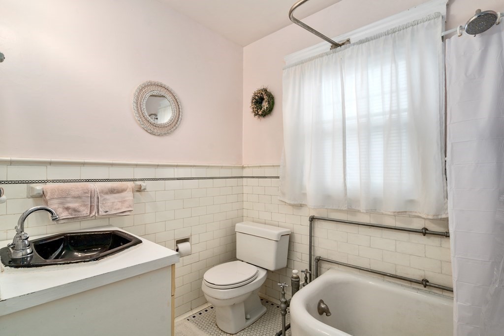 129 Standish Road Watertown, MA 02472 - Photo 13 of 17 a bathroom with a sink a toilet and shower