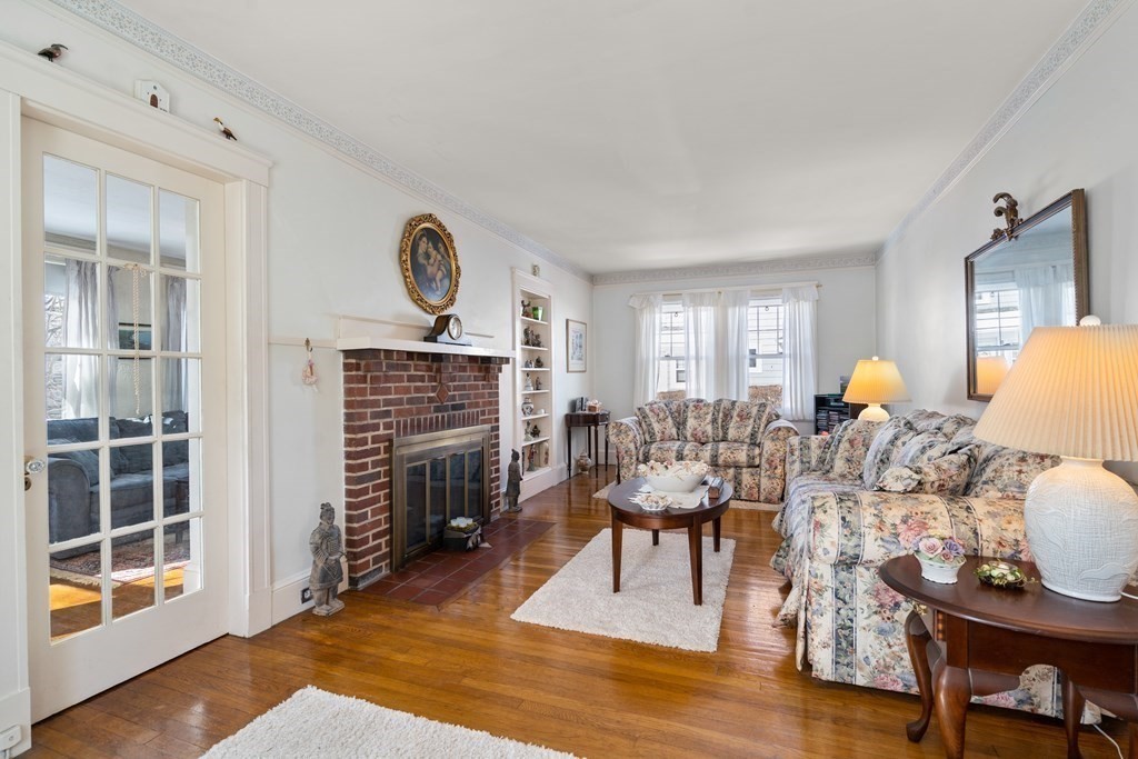 129 Standish Road Watertown, MA 02472 - Photo 3 of 17 a living room with fireplace furniture and a window