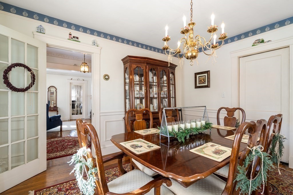 129 Standish Road Watertown, MA 02472 - Photo 5 of 17 a view of a dining room with furniture a chandelier and wooden floor