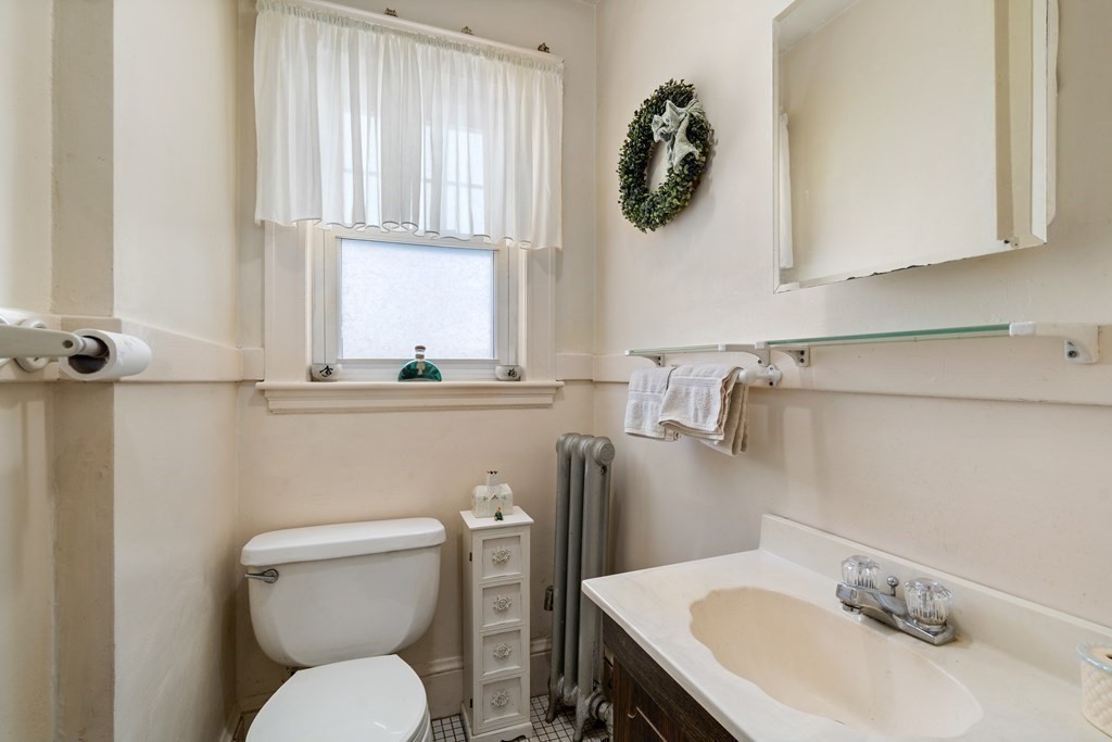 129 Standish Road Watertown, MA 02472 - Photo 8 of 17 a bathroom with a toilet sink and mirror