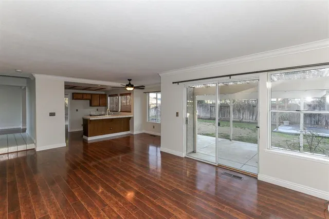 a room with wooden floors and fireplace