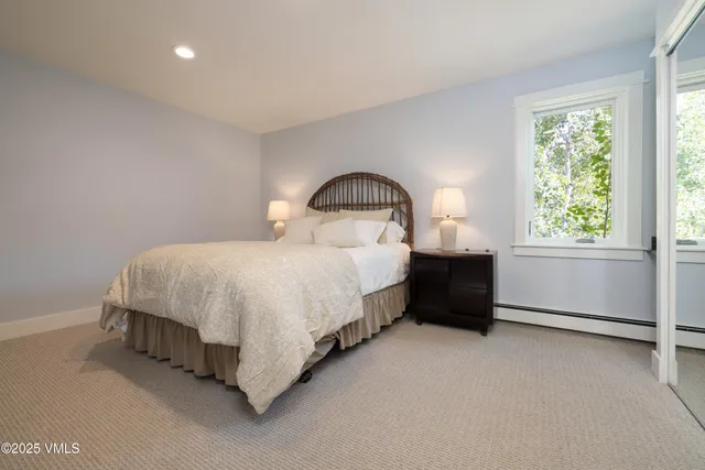 a spacious bedroom with a bed and a window