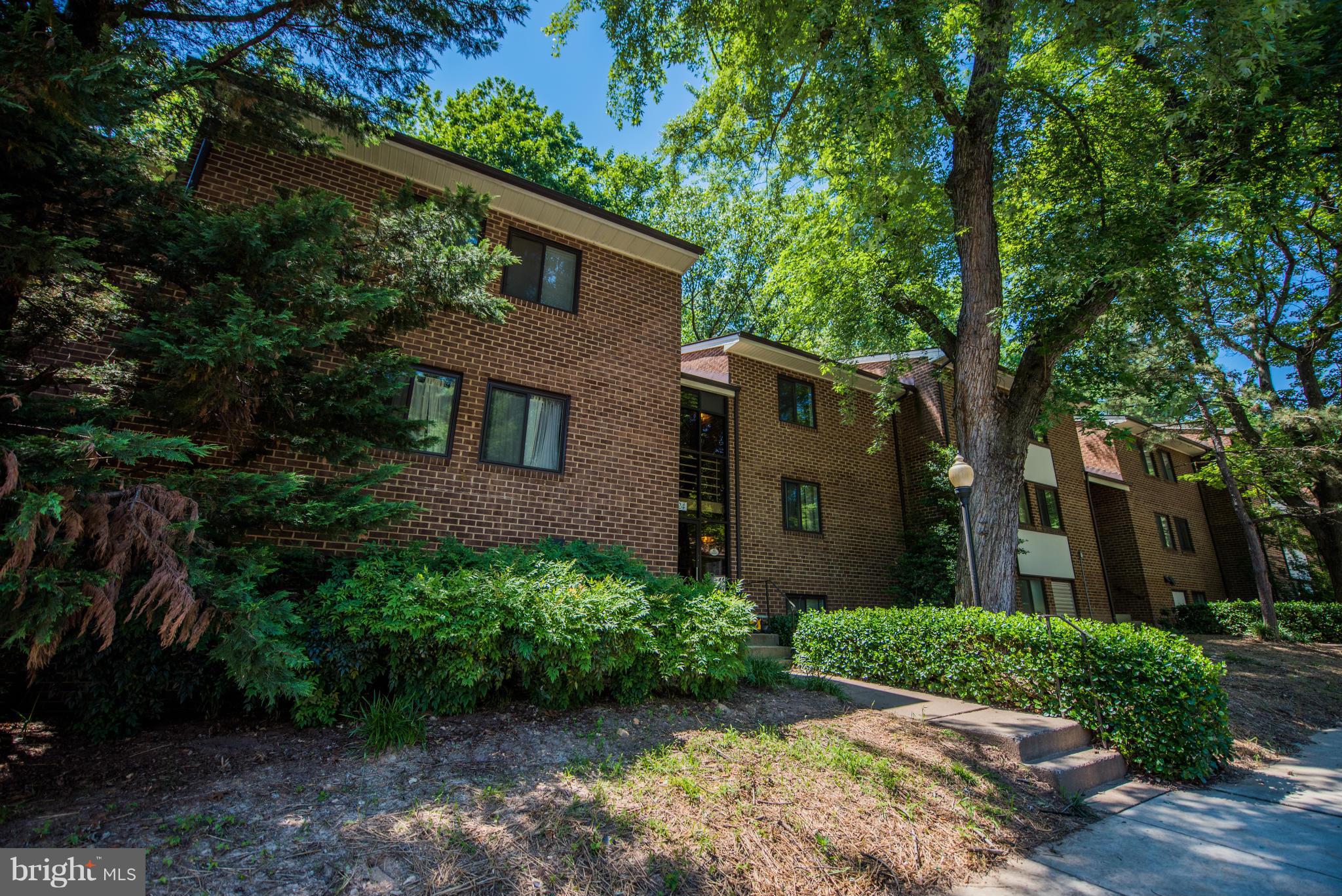 1524 Northgate Square, Unit 22A Reston, VA 20190 - Photo 1 of 17 a front view of a house with garden