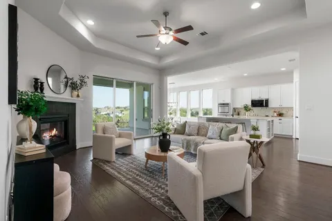 a living room with fireplace furniture and a wooden floor