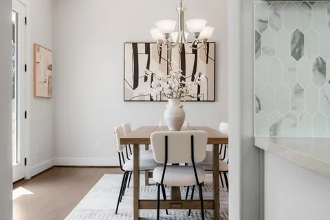a view of a dining room with furniture and chandelier