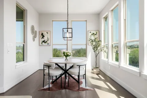 a view of a dining room with furniture window and wooden floor