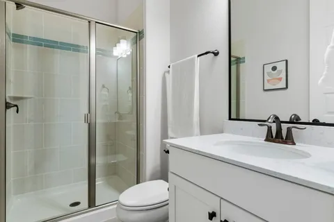 a bathroom with a sink toilet and shower