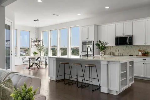 a kitchen with sink table and chairs
