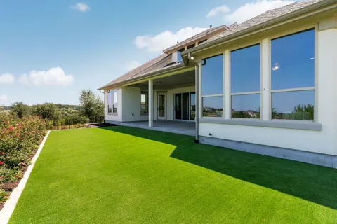 a view of house with backyard outdoor seating and plants