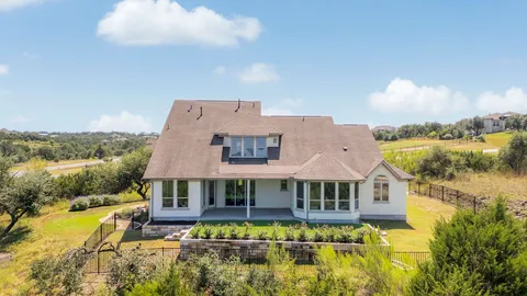 a aerial view of a house with swimming pool and a yard