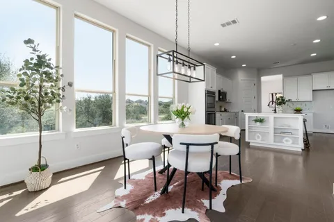 a dining room with furniture window and wooden floor
