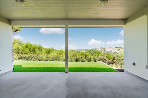 a view of a road with a small yard