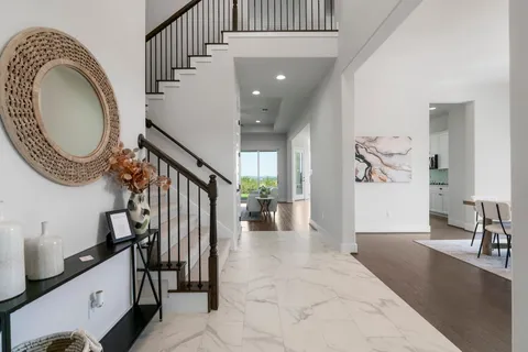 a view of entryway and hall with wooden floor