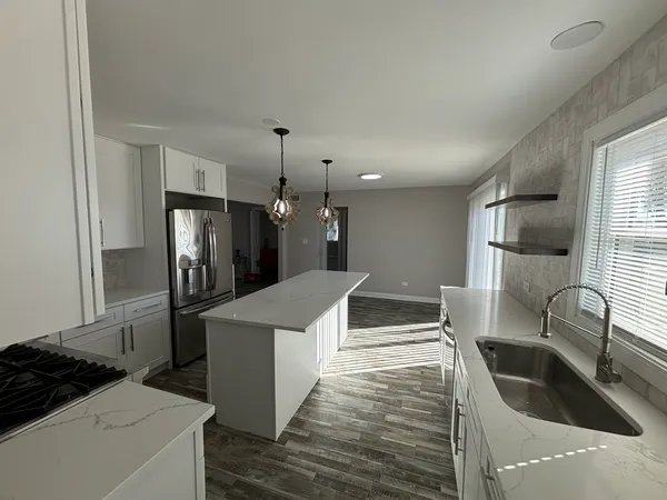 a kitchen with white cabinets and white appliances