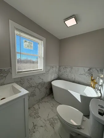 a bathroom with a sink a toilet and mirror