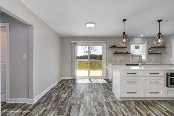 a kitchen that has a sink a stove and a refrigerator